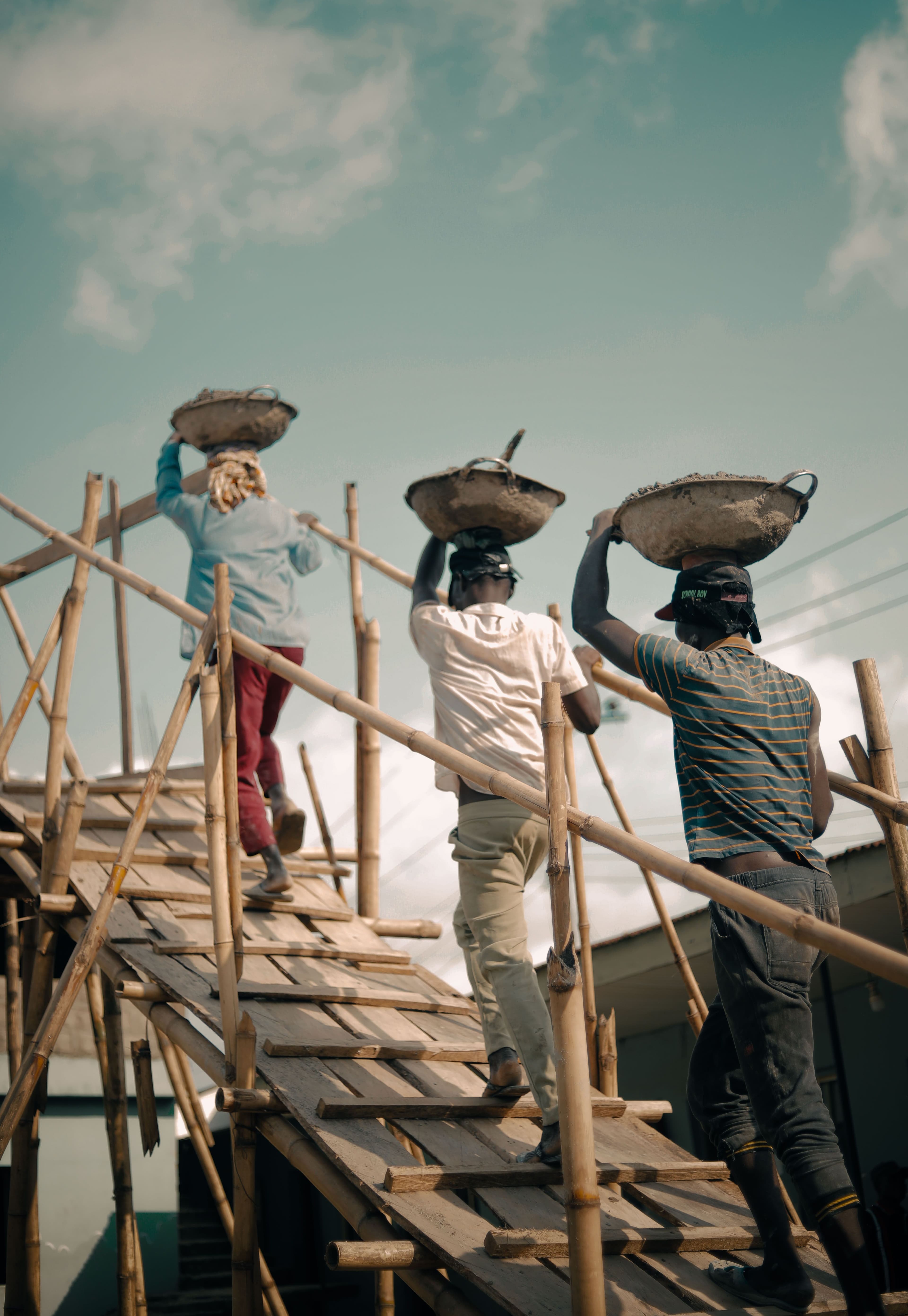 A construction site in Nigeria with workers and building materials.